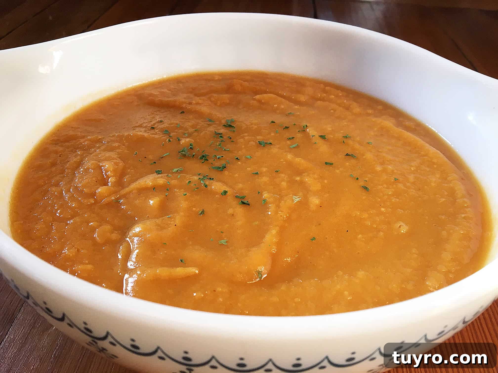 A bowl of sweet potato and apple soup.