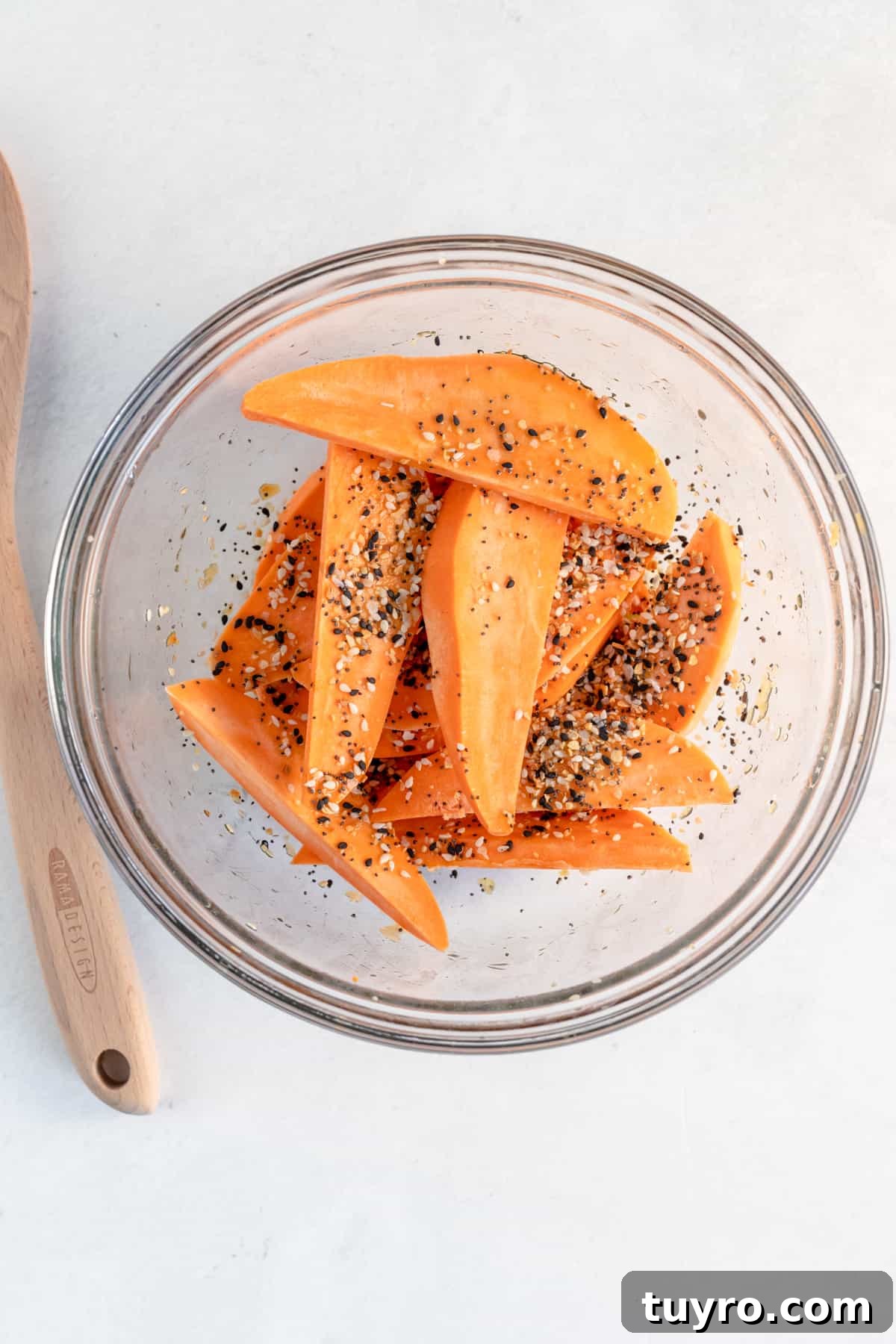 Crispy Air Fryer Sweet Potato Wedges Recipe 3 Sweet potato wedges tossed in seasoning and olive oil before going into the air fryer.