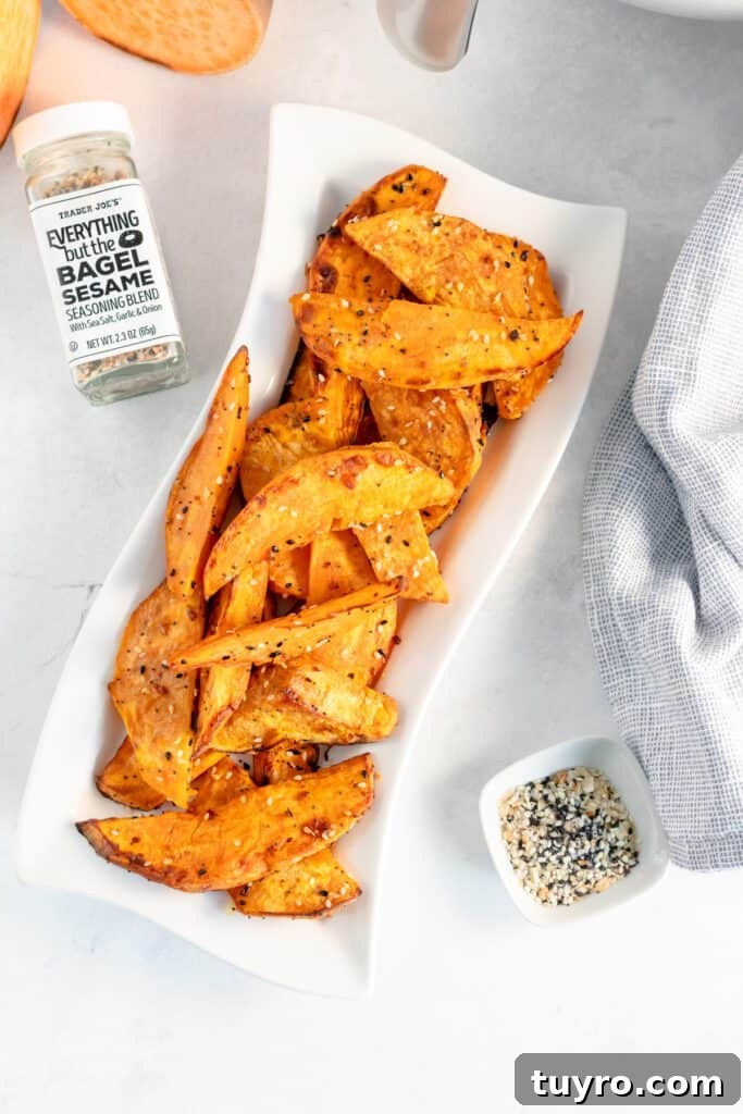 Crispy Air Fryer Sweet Potato Wedges Recipe 6 Sweet potato wedges with everything seasoning on a platter.