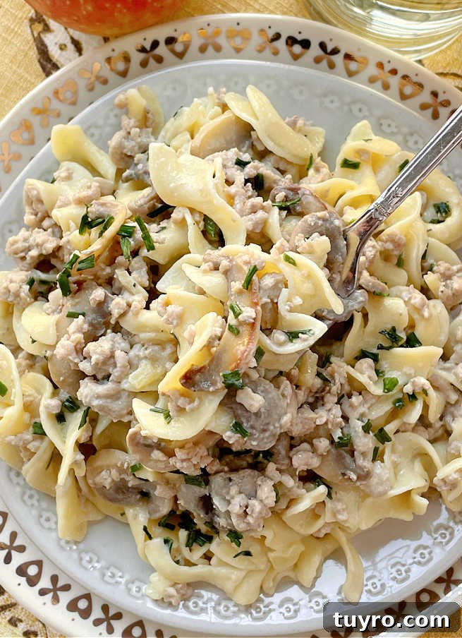 Creamy Ground Pork Stroganoff Recipe for Quick Weeknight Meals 3 taking a bite of pork stroganoff