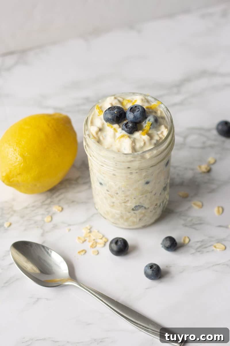 Lemon Blueberry Overnight Oats Recipe for Bright Morning Breakfast 5 Lemon Blueberry Overnight Oats in Glass Jar next to Spoon