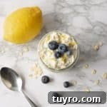 Lemon Blueberry Overnight Oats Overhead in Glass Jar topped with fresh blueberries