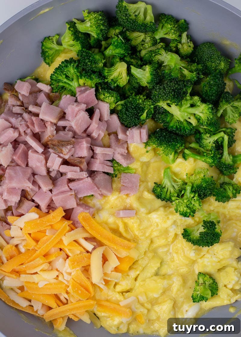 Ham, Broccoli and Cheddar Breakfast Scramble 8 Soft scrambled eggs in skillet