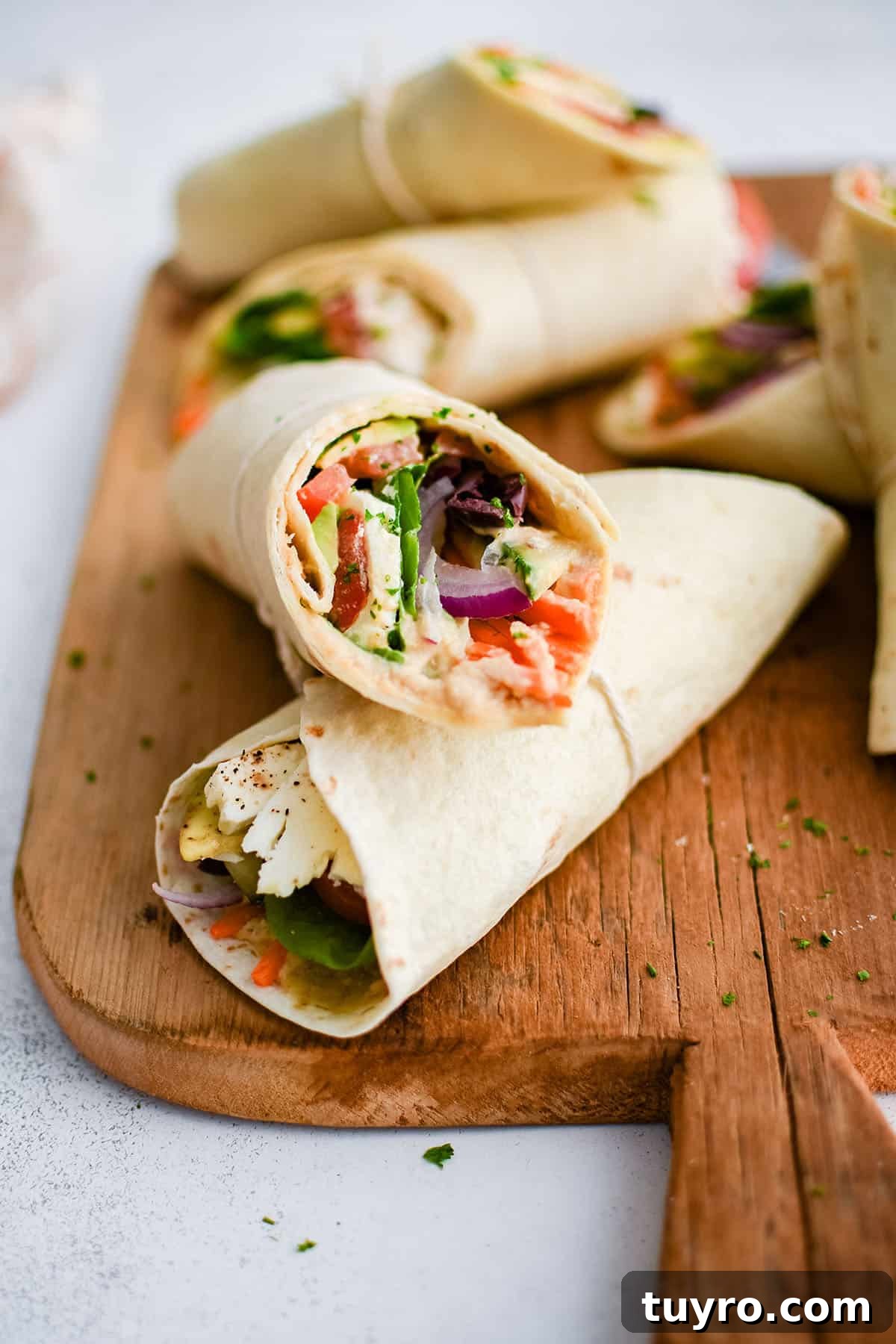 Fresh Vegetable Wrap Recipes for Quick Lunches 2 veggie wraps on a cutting board