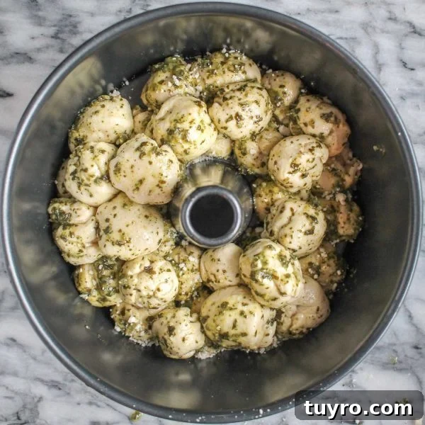 Pull-Apart Pesto Pizza Bread Recipe 5 Stacked pesto dough balls in pan ready to bake