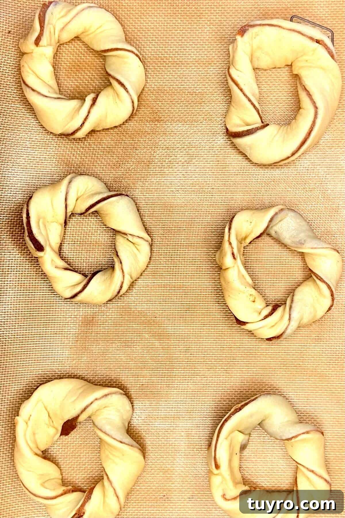 Cinnamon Roll Donuts: Soft Swirls with Cream Cheese Glaze 11 Forming donuts.