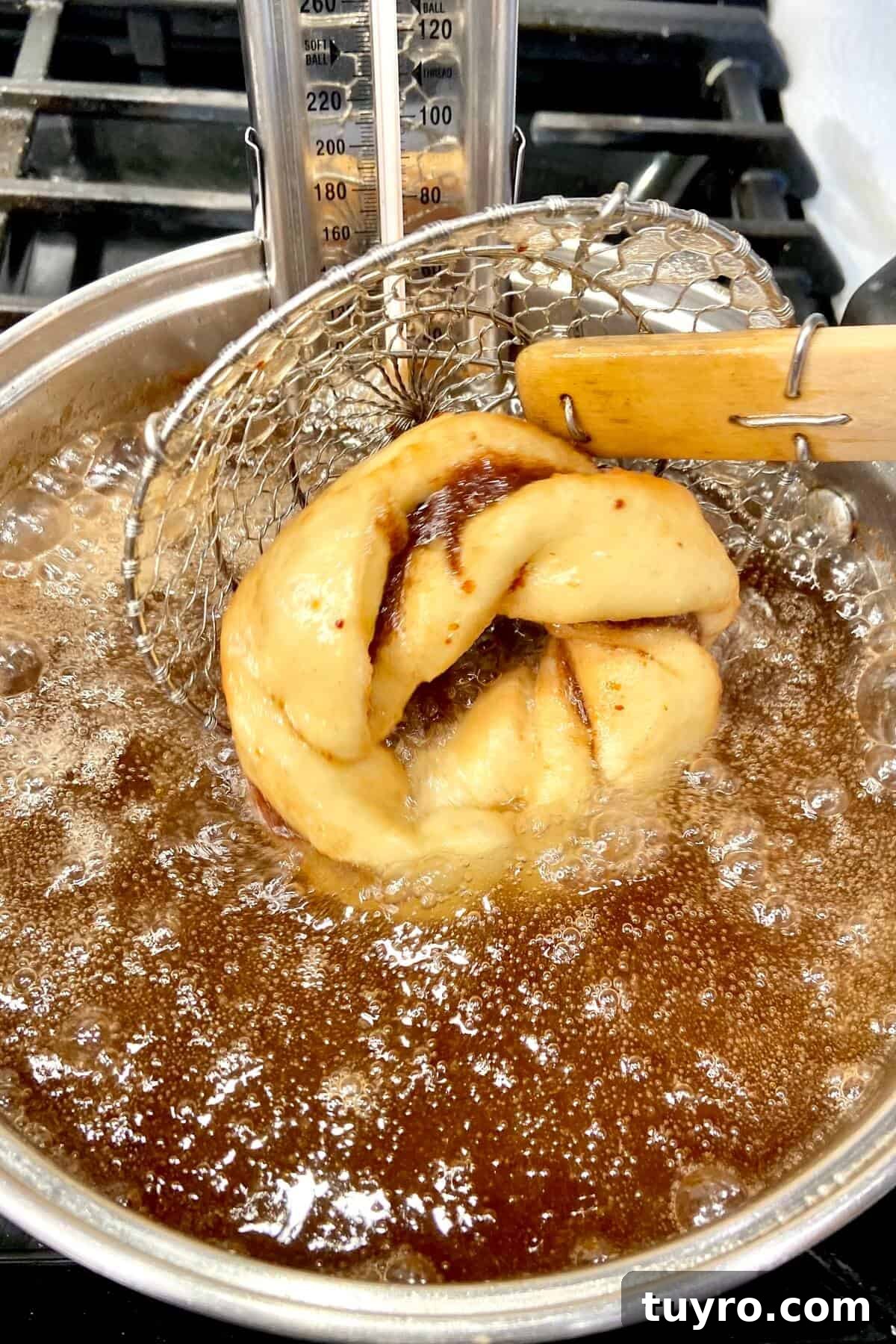 Cinnamon Roll Donuts: Soft Swirls with Cream Cheese Glaze 15 Turning the donut over, while it's frying in oil.