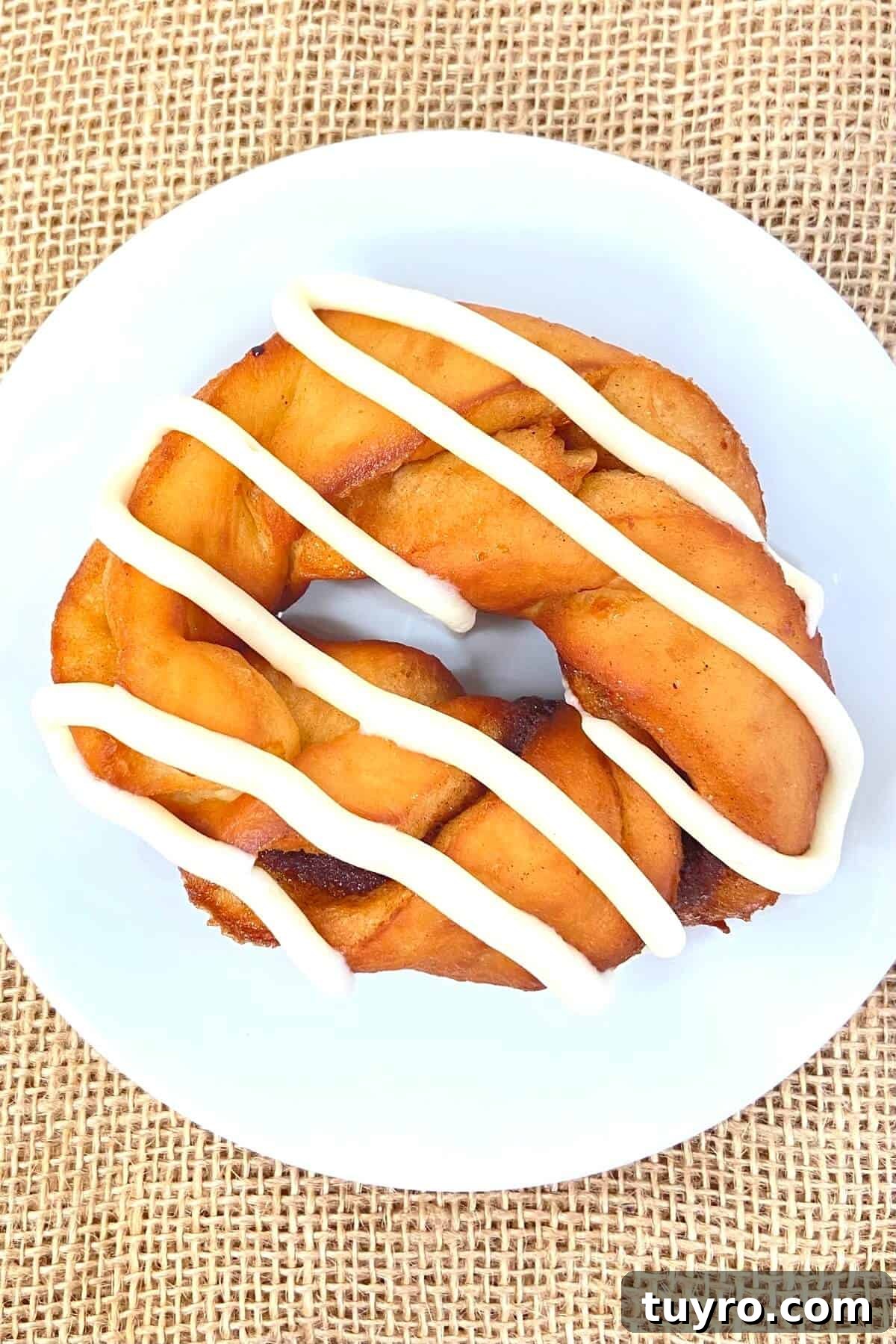 Cinnamon Roll Donuts: Soft Swirls with Cream Cheese Glaze 17 One donut on a plate.
