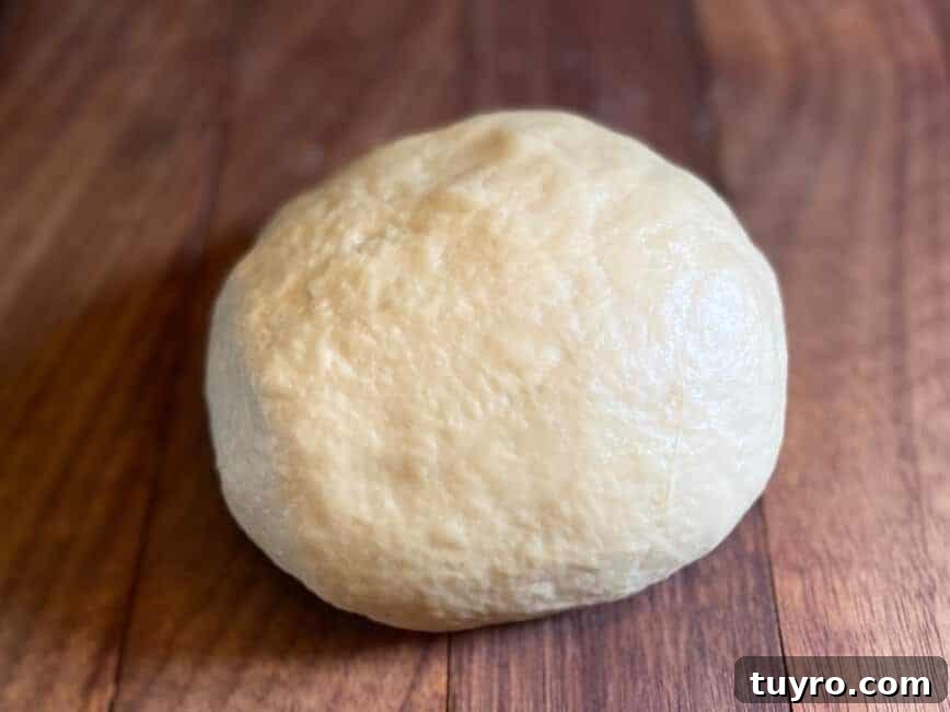 Cinnamon Roll Donuts: Soft Swirls with Cream Cheese Glaze 6 Dough formed into a ball.