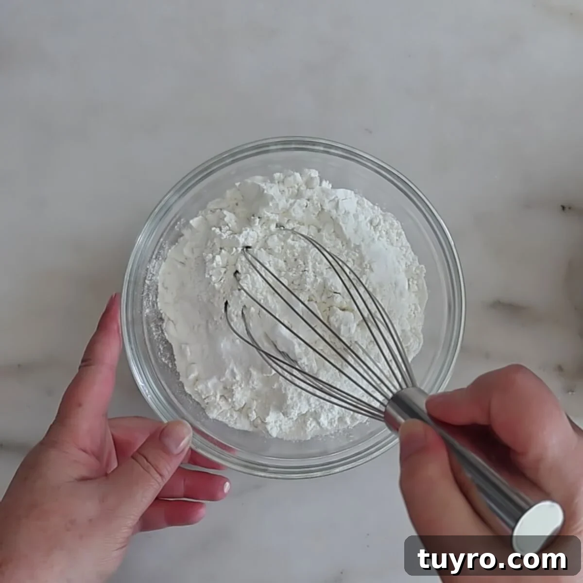 whisking dry ingredients in small glass bowl.