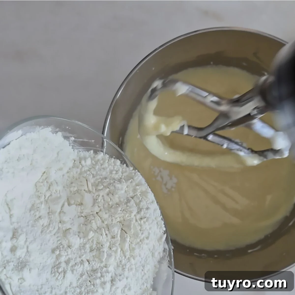 adding dry ingredients to batter in mixing bowl.