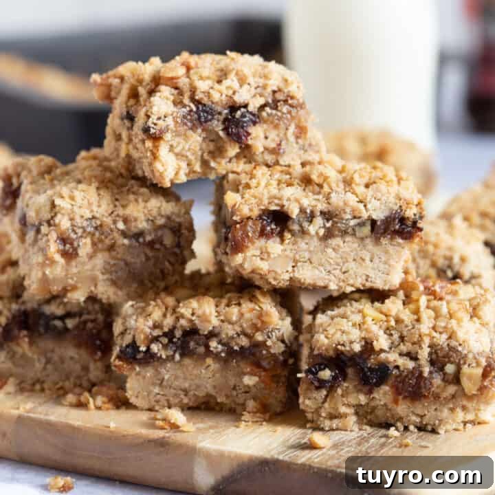 A stack of mincemeat crumble slices on a wooden board.