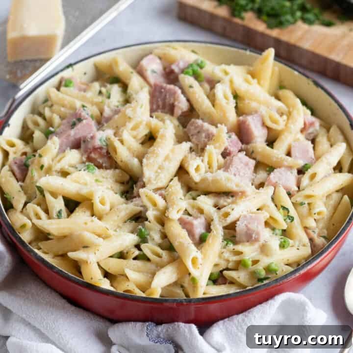Gammon ham pasta in a red pan.