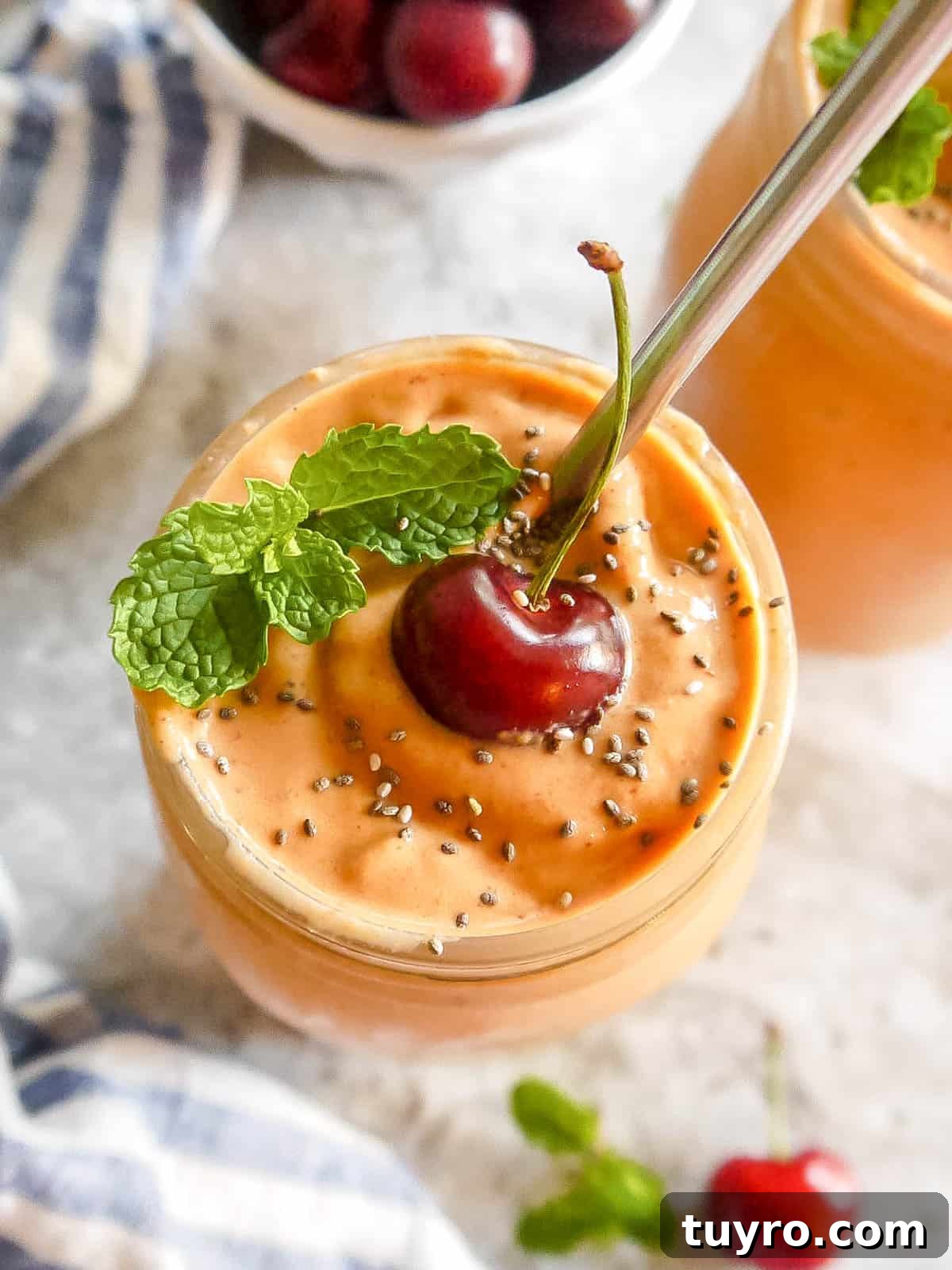 Smoothie with mango and carrot in a large cup.