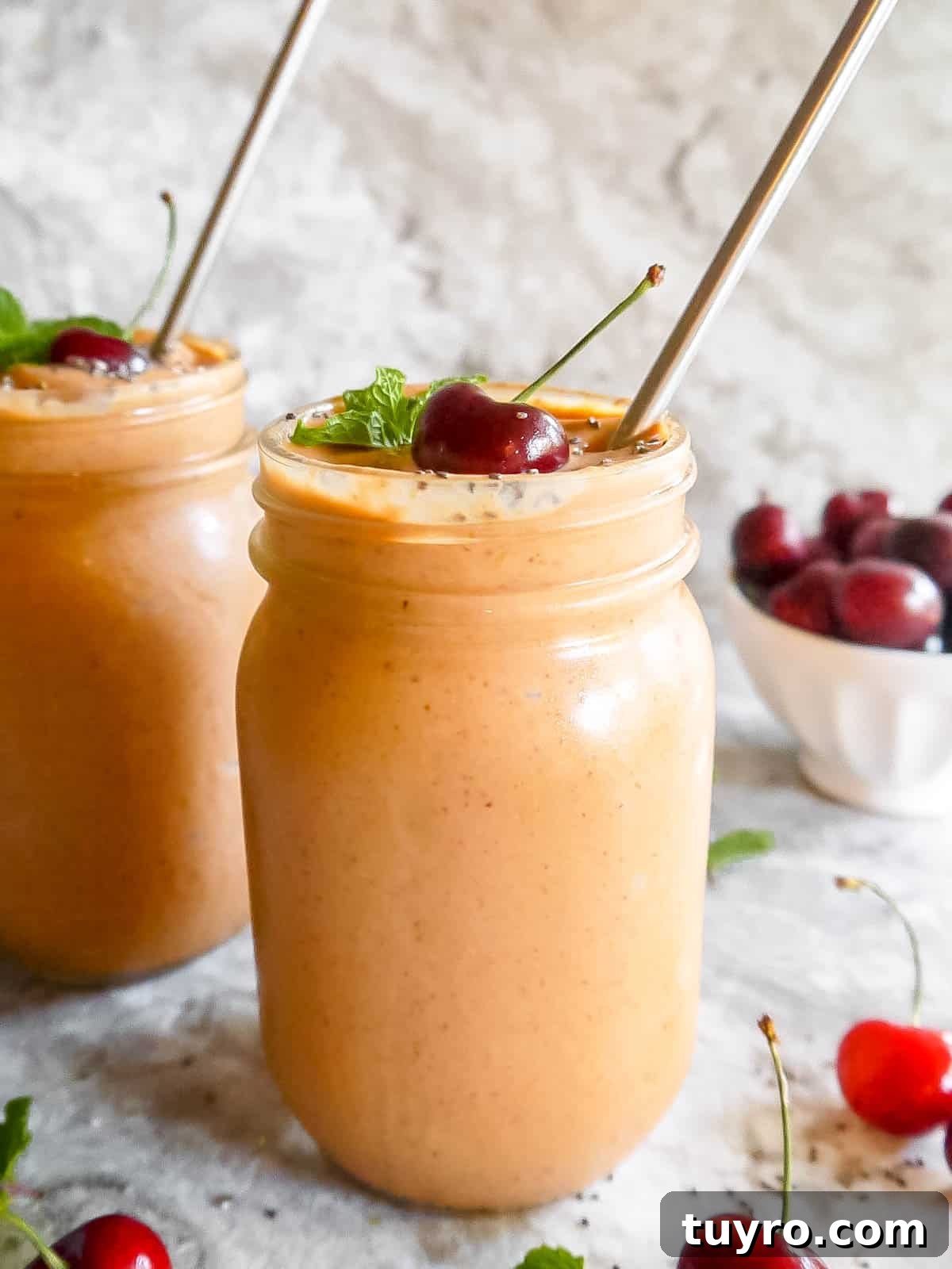 Mango carrot yogurt smoothie in two mason jars.