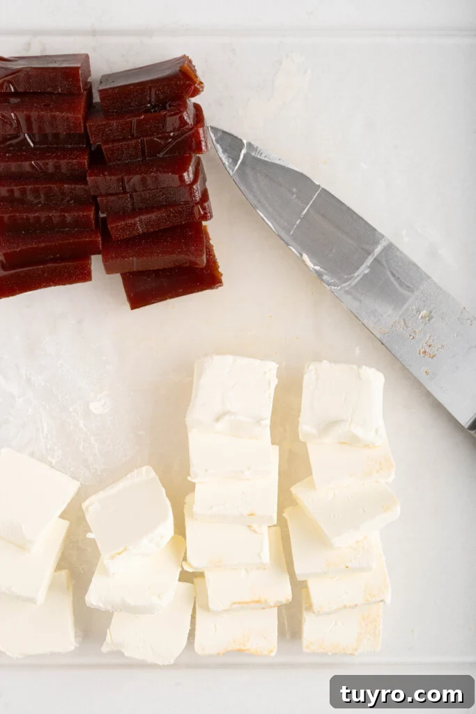 Guava Cheese Empanadas with 5 Ingredients — Quick Sweet Treat 7 pieces of guava paste and cream cheese with a knife