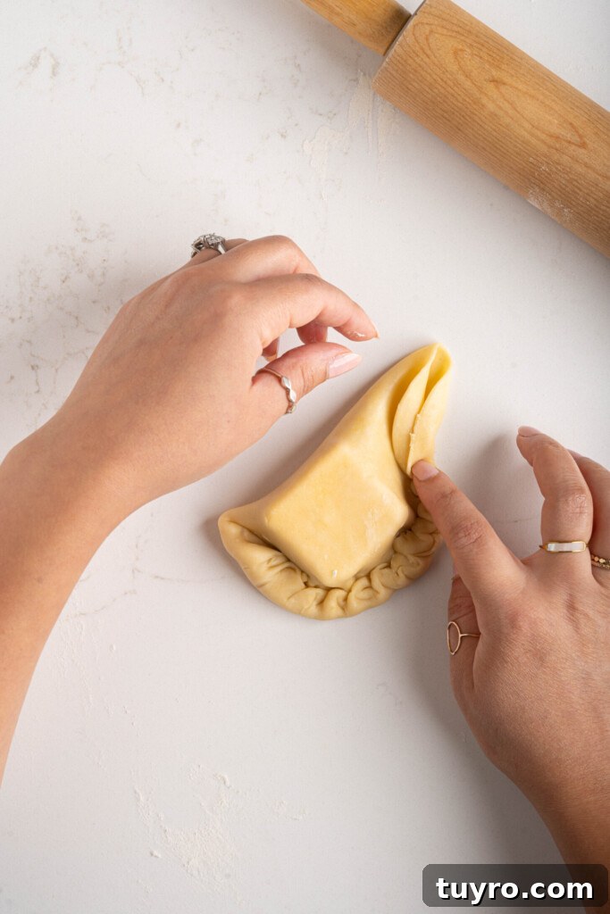 Guava Cheese Empanadas with 5 Ingredients — Quick Sweet Treat 9 two hands closing an empanada
