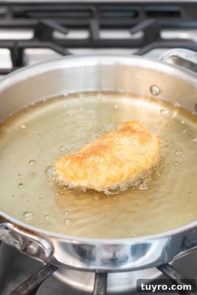 Guava Cheese Empanadas with 5 Ingredients — Quick Sweet Treat 10 an empanada frying in oil