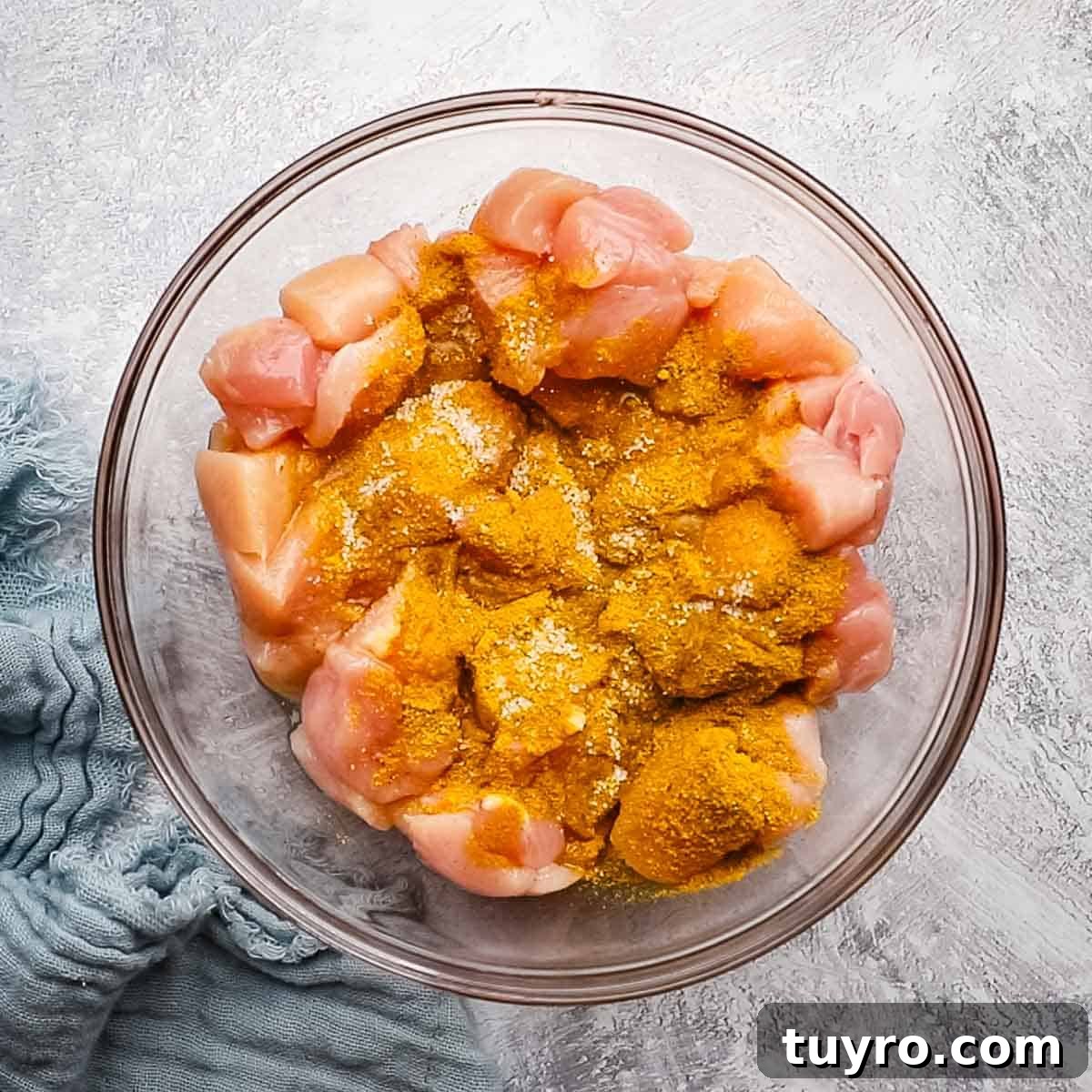 Chicken and Potato Curry Recipe 6 chicken cubes in a medium sized bowl with spices in it