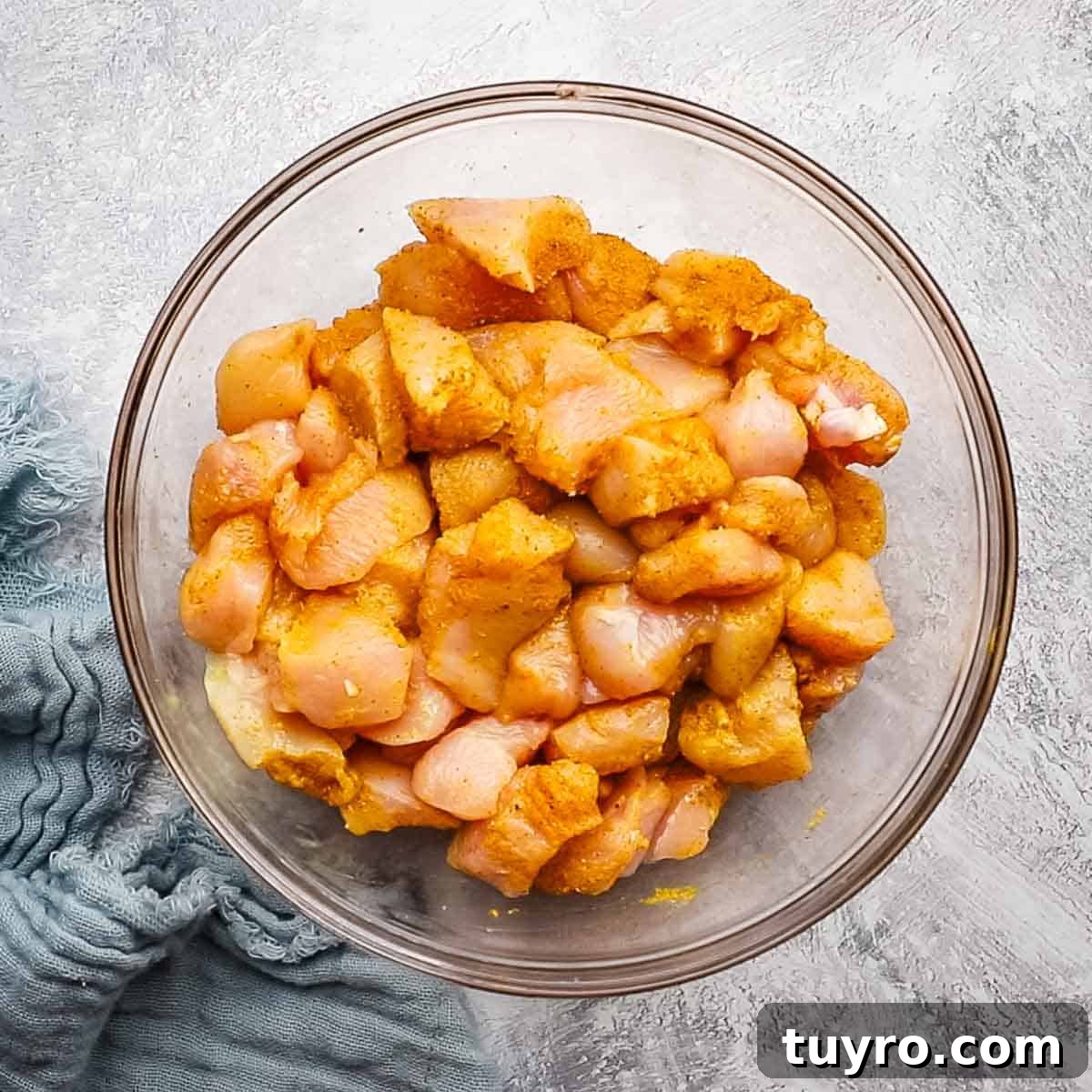 Chicken and Potato Curry Recipe 7 overhead view of marinated chicken in a bowl
