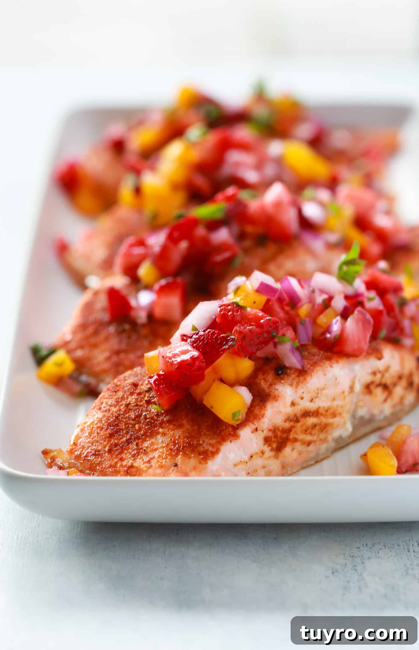 close up of 4 salmon fillets in a baking sheet