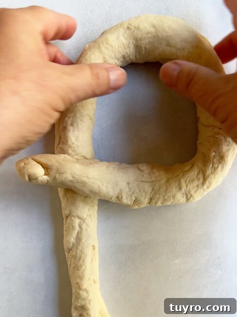 How to Braid Challah: Step-by-Step Visual Guide 10 Step 1 of making a single strand challah braid showing the key formation.