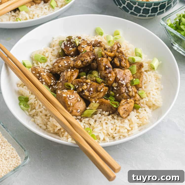 Blackstone Teriyaki Chicken Recipe: Sticky Glazed Griddle Chicken 9 Blackstone Teriyaki Chicken in a bowl over rice with chopsticks
