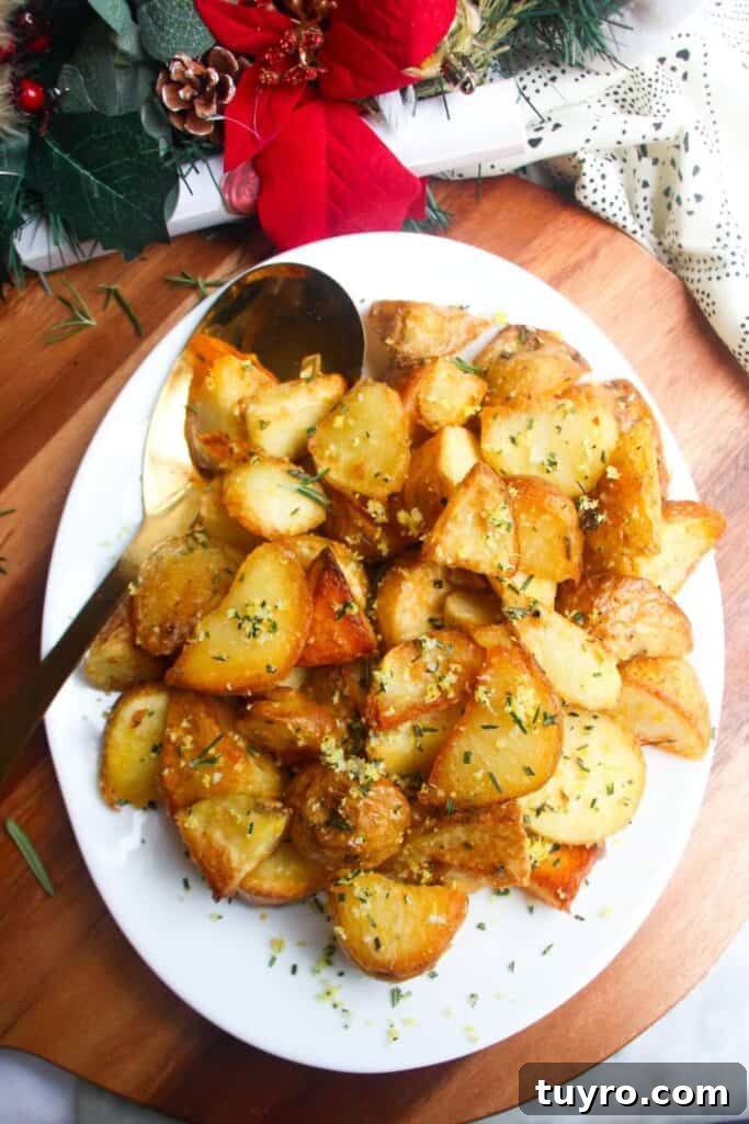 Top Christmas Side Dishes: 13 Festive Recipes for Your Holiday Table 2 Crispy golden potatoes on a white oven plate with large gold spoon on a wooden background.