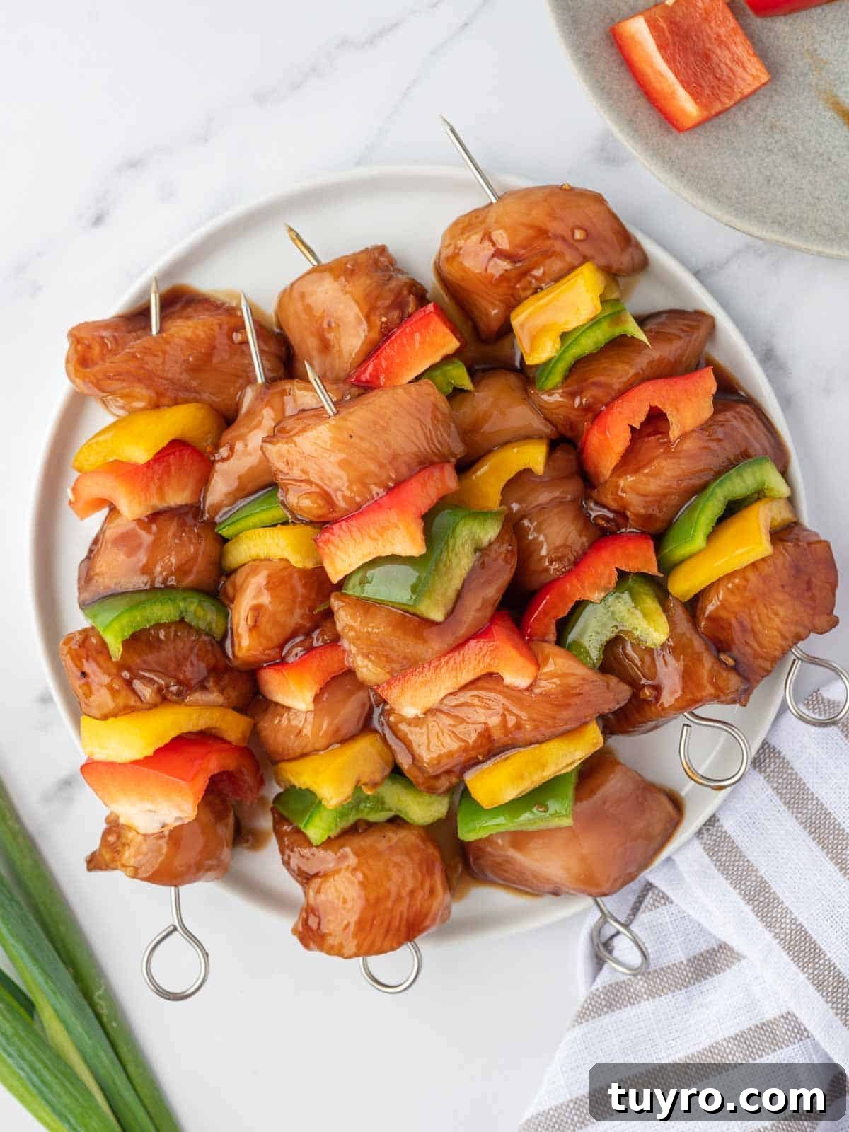 Marinated teriyaki chicken prepared for grilling.