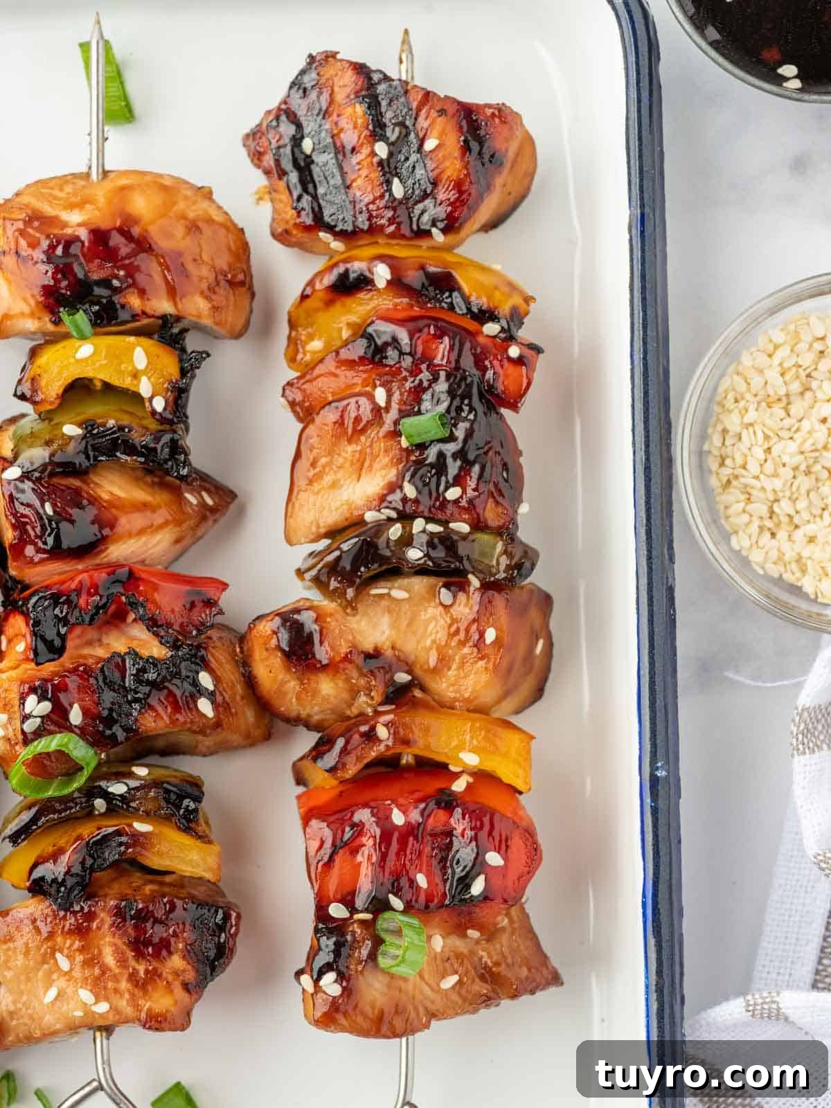 Closeup of a teriyaki chicken kabob on a platter.