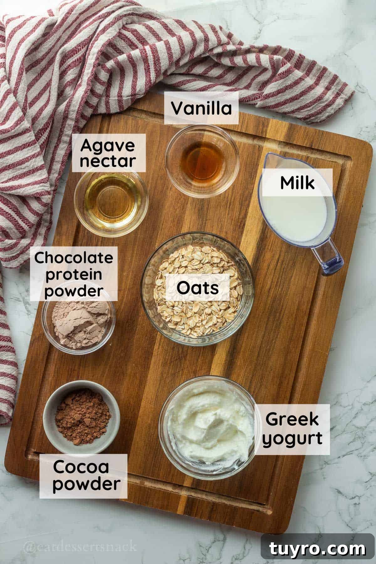 Brownie Batter Overnight Oats Recipe for Indulgent Breakfast 3 Ingredients for brownie batter overnight oats in glass bowls on wood cutting board with dish towel.