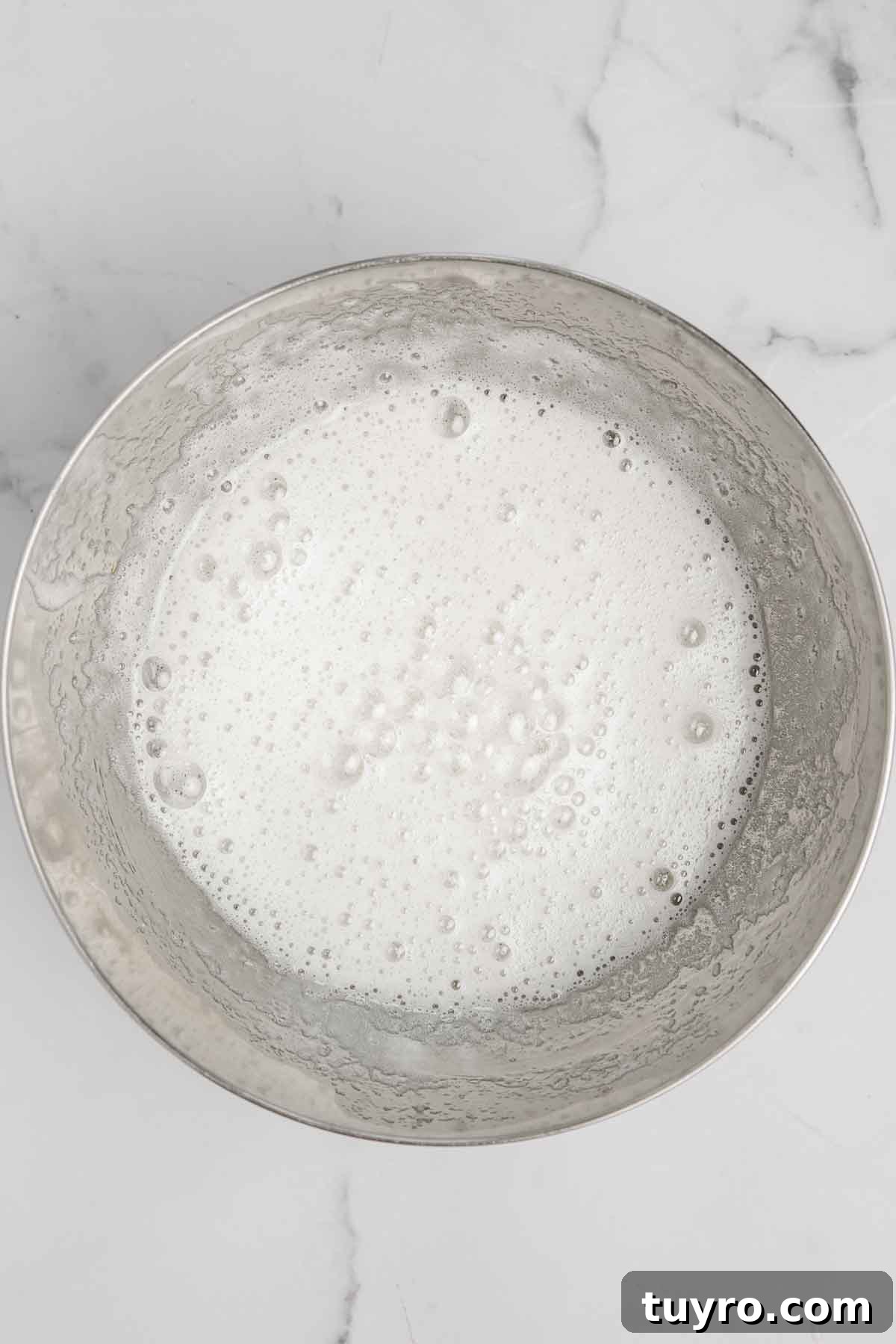 White Chocolate Swiss Meringue Buttercream Recipe 4 bowl with cooked egg whites and sugar