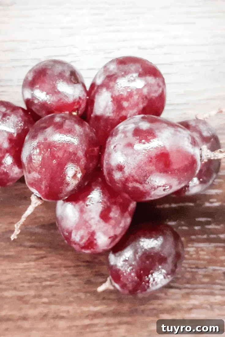 Frozen red grapes on wood