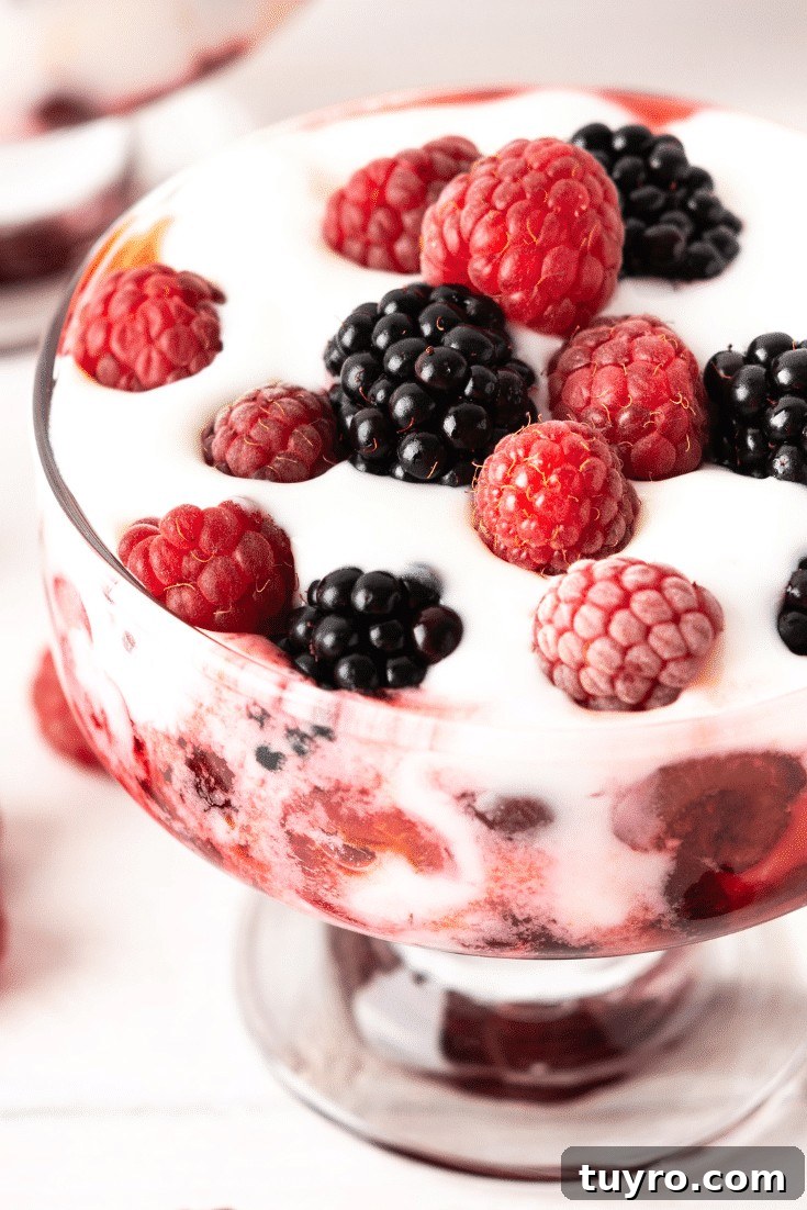 Glass bowl with coconut cream and mixed berries
