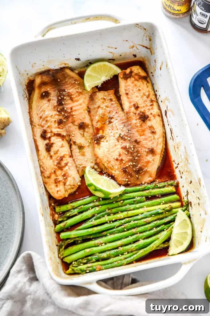 Ginger-Soy Tilapia with Broiled Asparagus Recipe 7 fresh from the oven ginger soy tilapia with broiled asparagus in a shallow white baking dish.