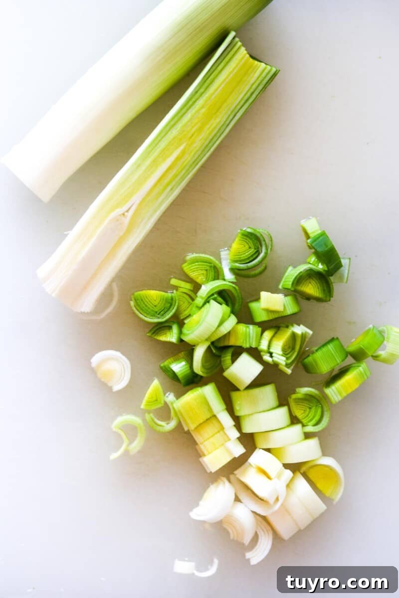 Creamy Asparagus Soup with Leeks and Peas 5 Chopped leeks on a cutting board.