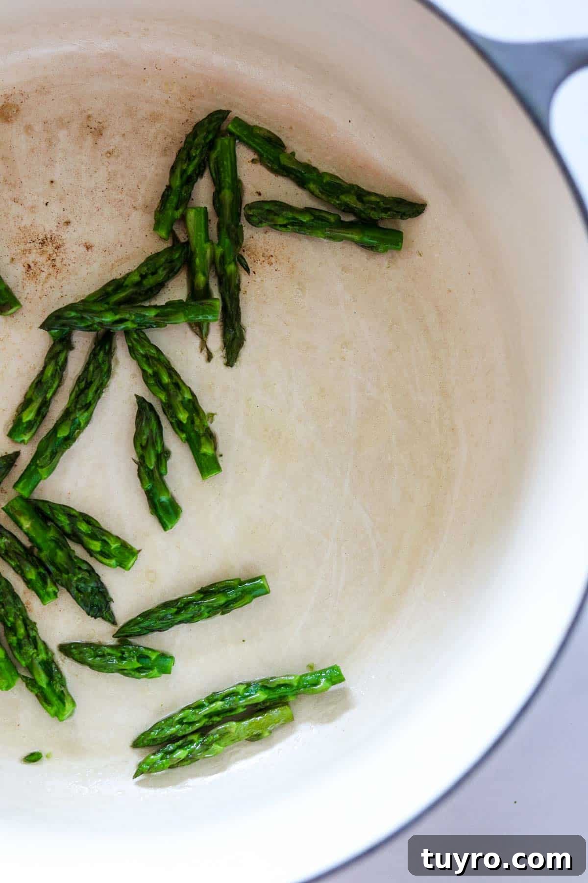 Creamy Asparagus Soup with Leeks and Peas 6 Asparagus tips in a pot.