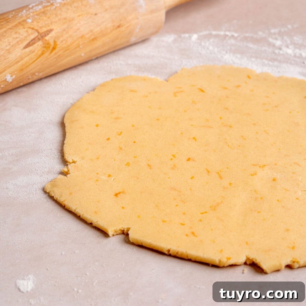 Honey Orange Shortbread Cookies — No-Chill Cut-Out Recipe 7 Orange shortbread cookie dough rolled out on a lightly floured surface.