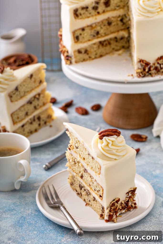 Butter Pecan Cake with Cream Cheese Frosting Recipe 18 Slices of layered vanilla cake studded with buttered pecans frosted with cream cheese frosting on a white plate