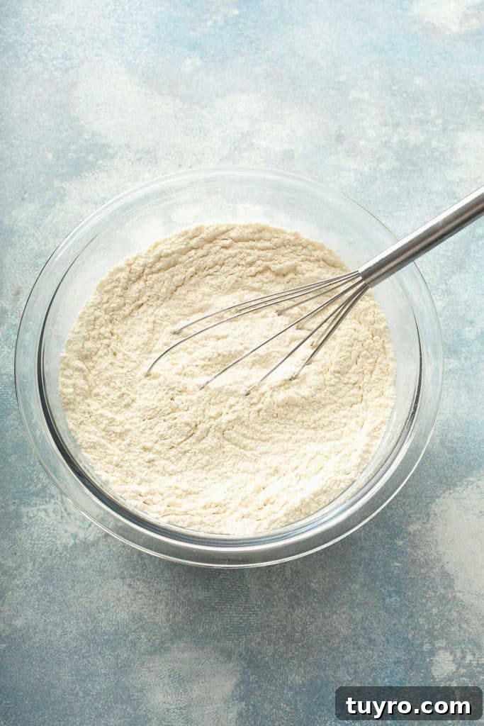 Butter Pecan Cake with Cream Cheese Frosting Recipe 7 dry ingredients in a bowl with a whisk