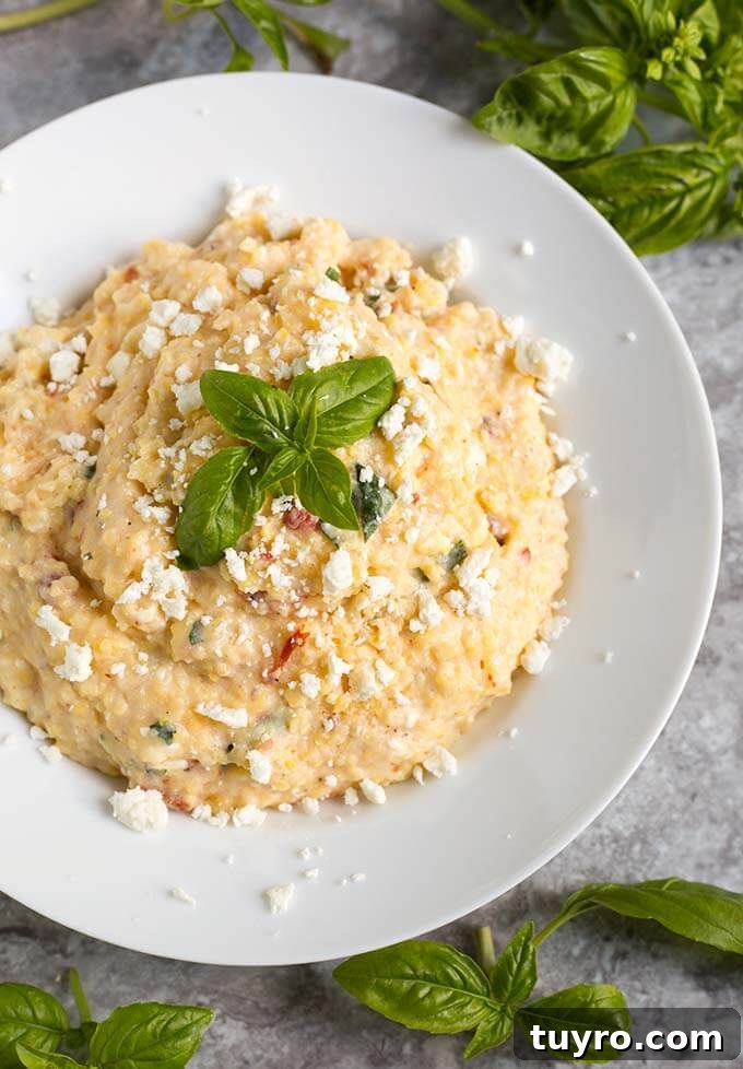 Creamy Instant Pot Polenta Recipe 5 Polenta on a white plate garnished with basil