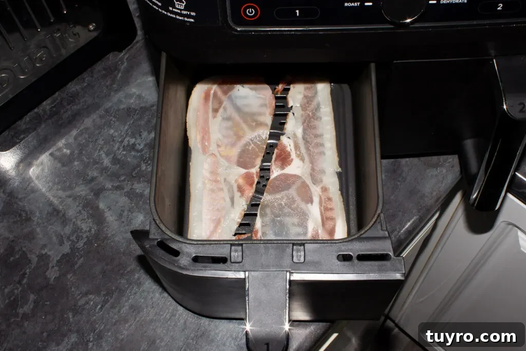 Crispy 10-Minute Air Fryer Bacon Recipe (UK) 9 Uncooked back bacon in an air fryer