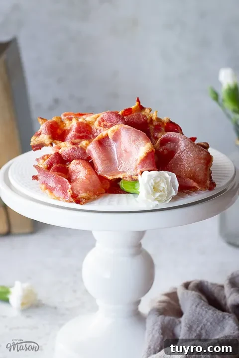 Crispy 10-Minute Air Fryer Bacon Recipe (UK) 3 Close up of air fried bacon on a white plate