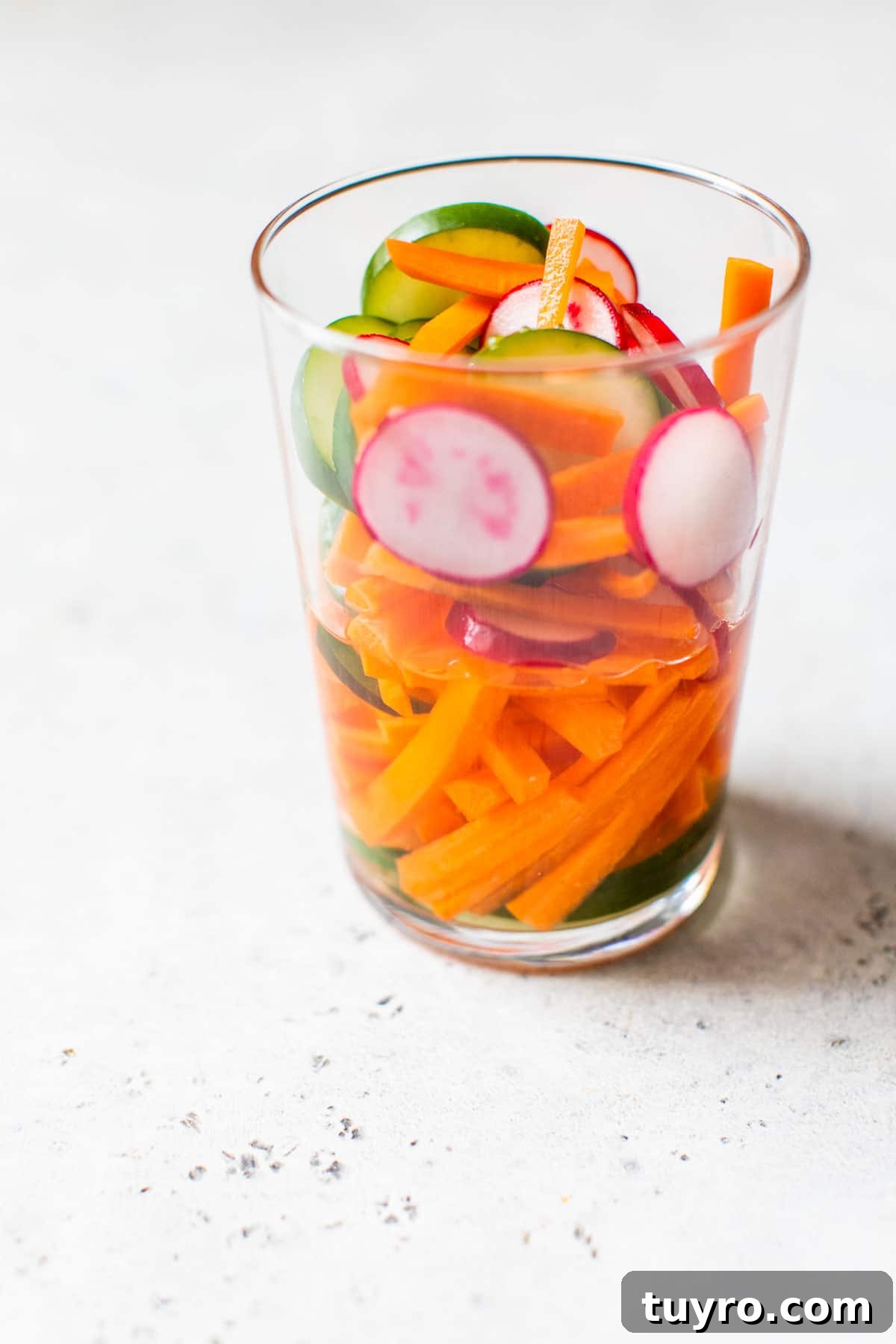 Tofu Banh Mi Sandwich with Pickled Vegetables 4 sliced vegetables in a cup with vinegar