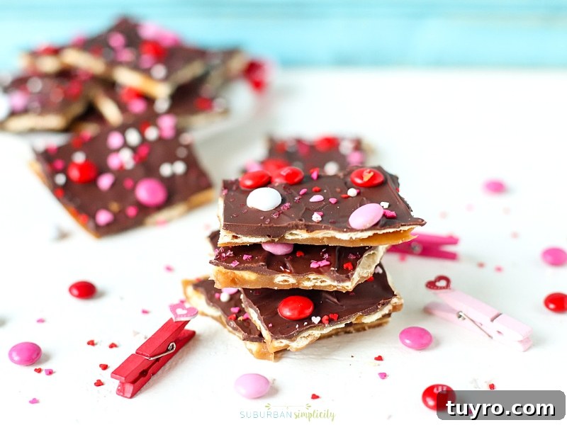 Valentines Day Puppy Chow Recipe 3 Valentine's Day Saltine Toffee Stacked together on a table.