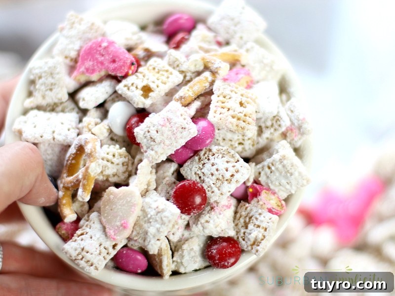 Valentines Day Puppy Chow Recipe 4 Bowl full of Valentine's Day puppy chow with M&Ms.