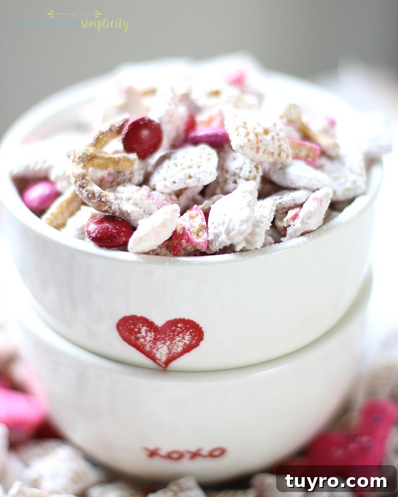 Valentines Day Puppy Chow Recipe 6 Two Valentine's Day bowl stacked with Valentine's Day Puppy Chow inside.