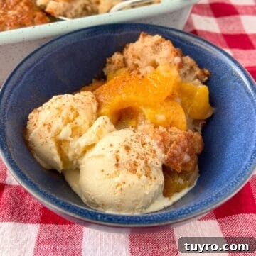 Classic Southern Peach Cobbler Recipe – Authentic & Irresistible 6 Peach cobbler in blue bowl.
