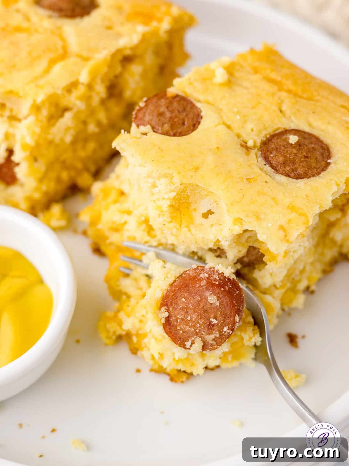 Corn Dog Casserole with Cornbread and Hot Dogs 5 bite of corn dog casserole on fork