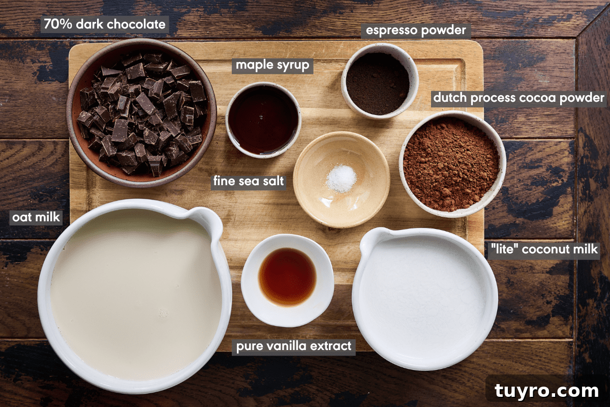 Creamy Vegan Hot Chocolate Recipe 4 Hot chocolate ingredients in various bowls on a wood cutting board on a wood table.